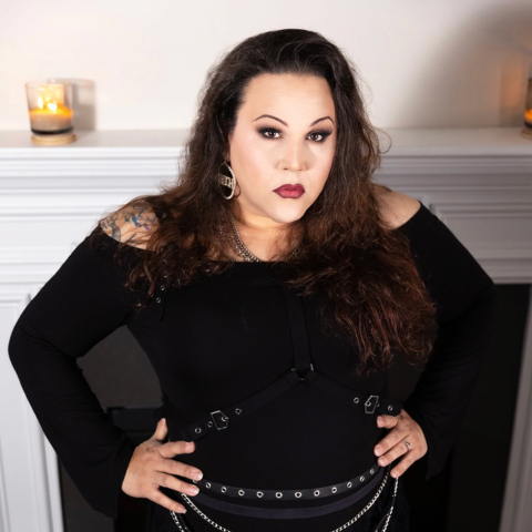 Domina Alluriah, looking at us with her hands on her hips