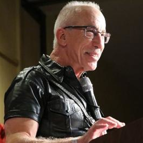 slave Rick profile shot in black leather shirt